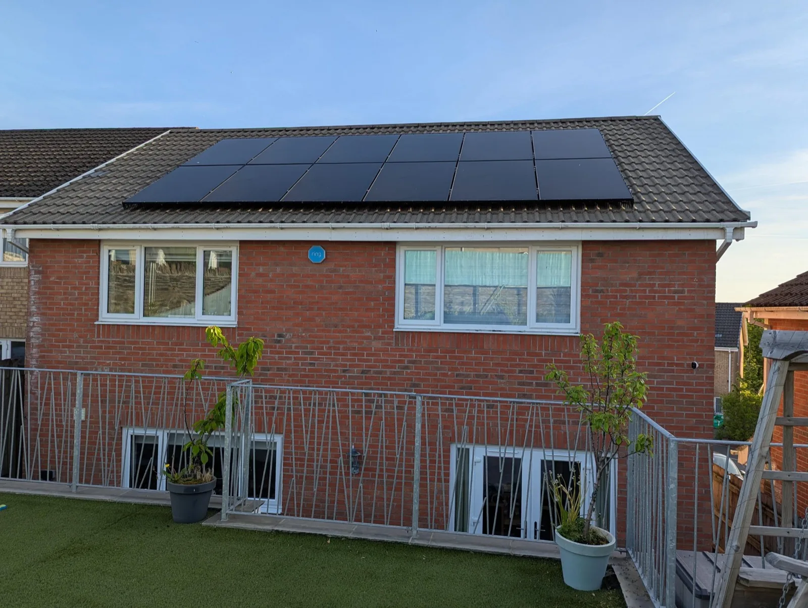Solar PV installation on a red-brick semi at sunset — Blue Electrics